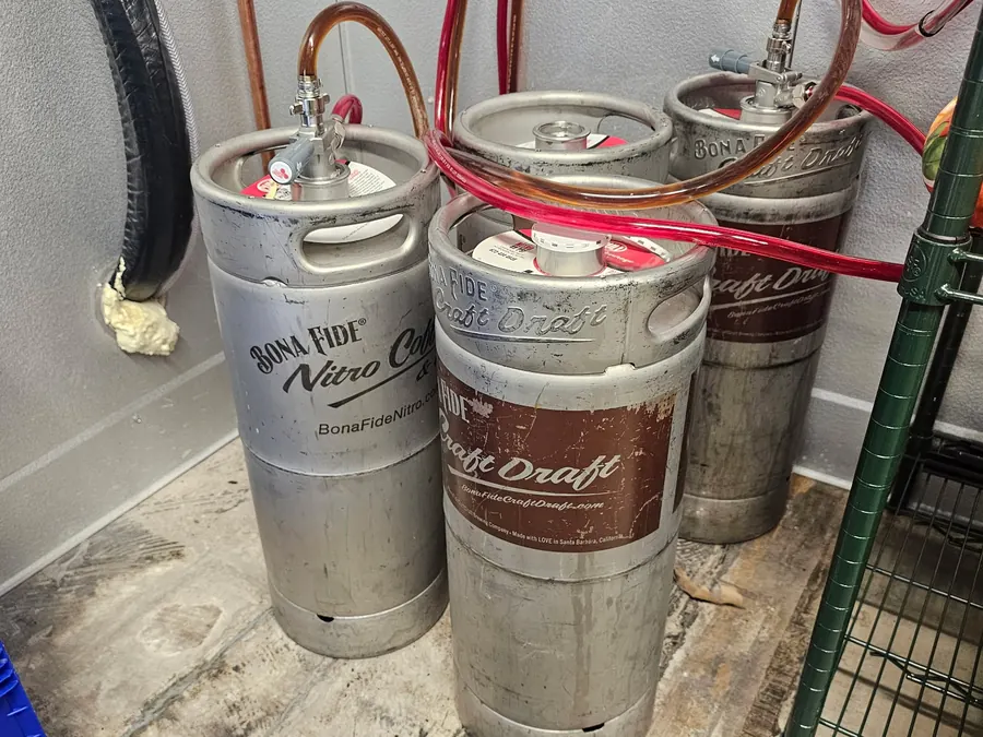 Bona Fide nitro coffee kegs coupled to gas lines in a cooler