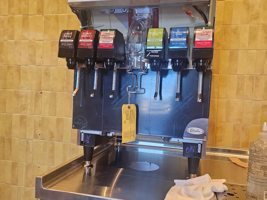 New Cornelius soda fountain set on a stainless counter at Cava with the protective film still on